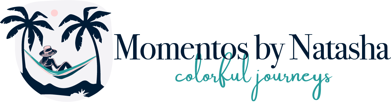 A logo on a white background with the text 'Momentos by Natasha' in dark navy and 'colorful journeys' in teal script. To the left is a circular graphic showing palm trees, a hammock with a person relaxing inside, and a small pink sun.